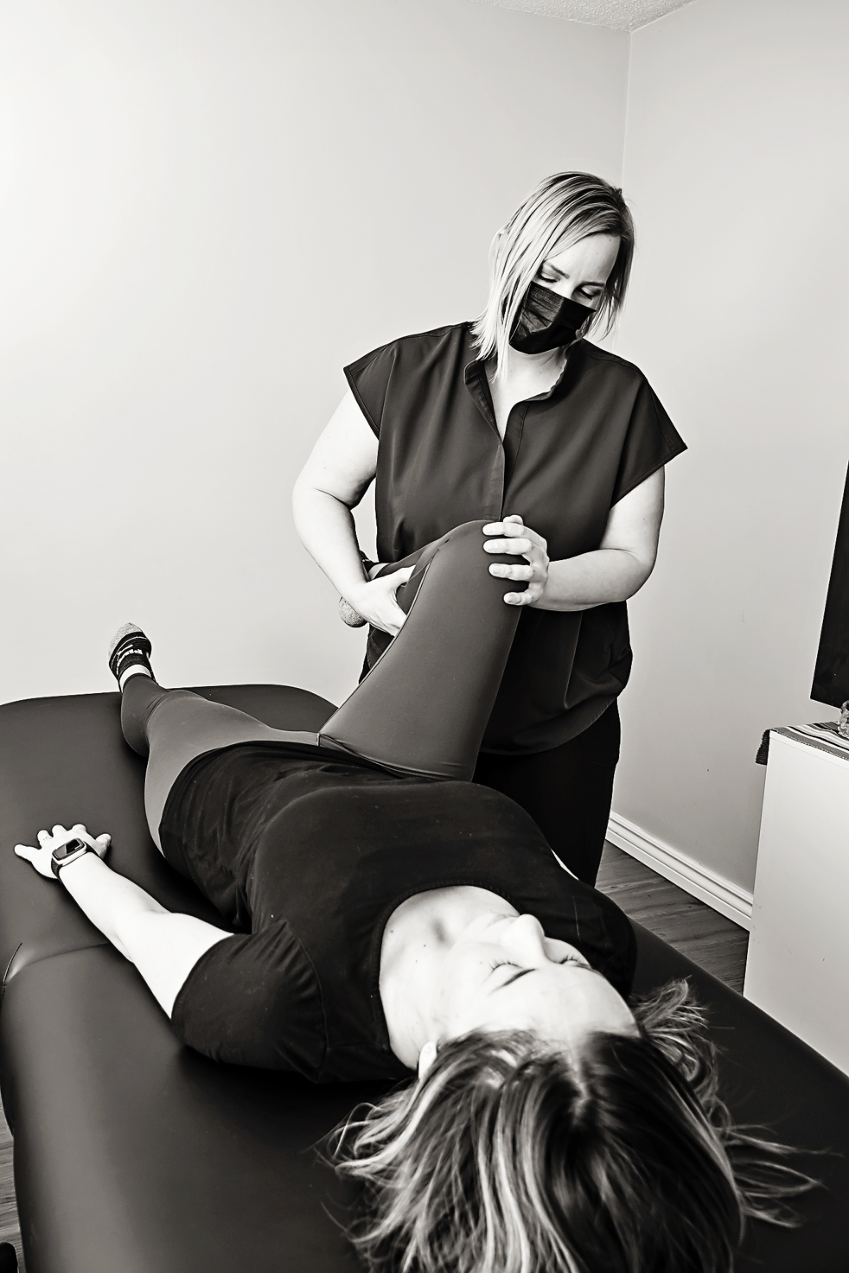 Manual Osteopathic Therapist treats child with cranial osteopathy on treatment table with hands